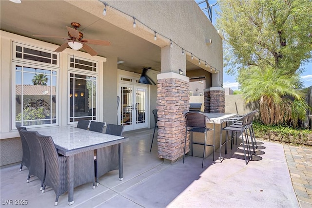 view of patio featuring french doors and ceiling fan