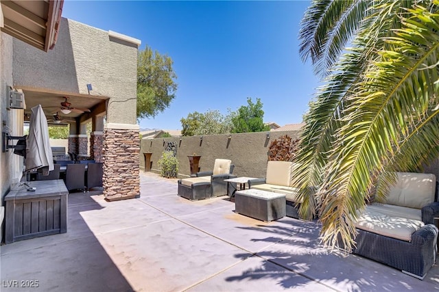 view of patio with a ceiling fan, outdoor lounge area, and a fenced backyard