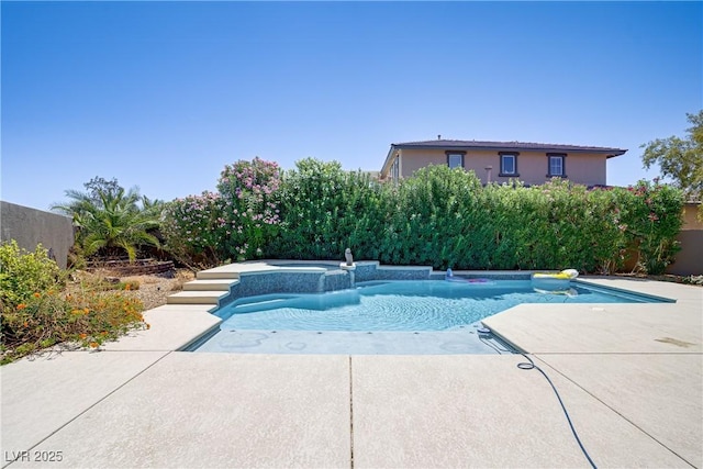 view of pool featuring a pool with connected hot tub and a patio