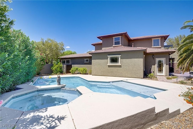 view of swimming pool featuring fence and a pool with connected hot tub