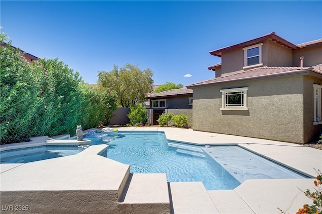 view of pool featuring a fenced backyard, a patio area, and a pool with connected hot tub