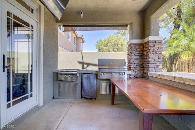 view of patio / terrace with area for grilling and a grill
