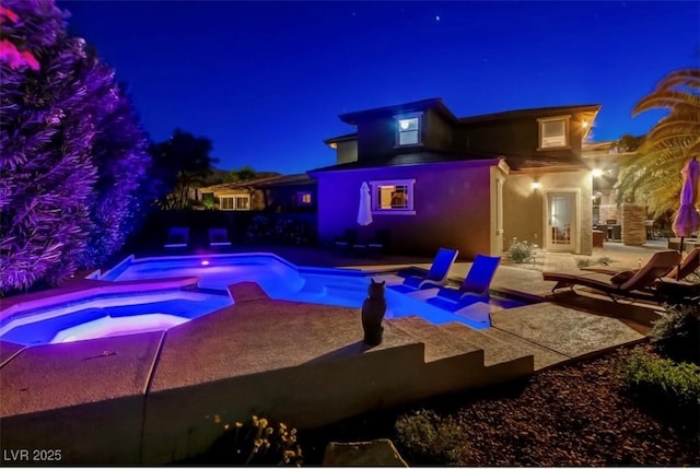 10520 Maystar Ln, Las Vegas, NV 89135 - pool at twilight with an in-ground hot tub, a patio, and an outdoor pool