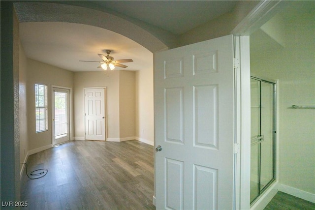 6160 Rumrill St Unit 121, Las Vegas, NV 89113 - foyer with arched walkways, wood finished floors, ceiling fan, and baseboards