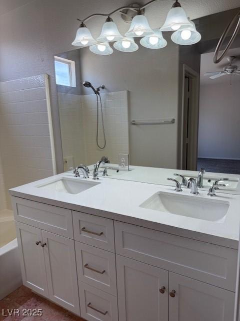 bathroom with double vanity,  shower combination, ceiling fan, and tile patterned floors