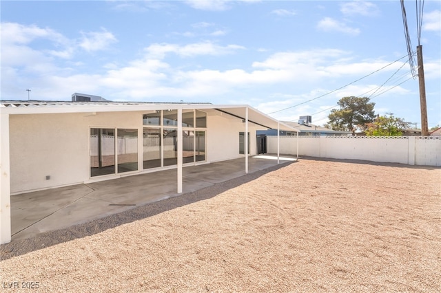 6205 Hargrove Ave, Las Vegas, NV 89107 - back of property featuring fence, stucco siding, and a patio