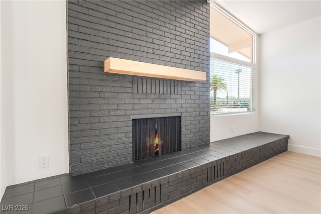 6205 Hargrove Ave, Las Vegas, NV 89107 - detailed view of a fireplace, wood finished floors, and baseboards