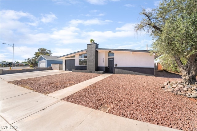 6205 Hargrove Ave, Las Vegas, NV 89107 - mid-century inspired home featuring driveway, stucco siding, and an attached garage