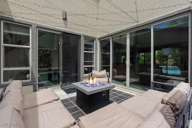9710 Hiking Ave, Las Vegas, NV 89166 - sunroom with an outdoor living space with a fire pit and expansive windows