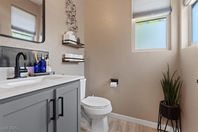 9710 Hiking Ave, Las Vegas, NV 89166 - half bath featuring wood finished floors, toilet, vanity, and baseboards