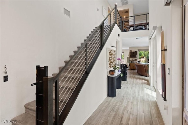 9710 Hiking Ave, Las Vegas, NV 89166 - stairway featuring wood finished floors and a high ceiling