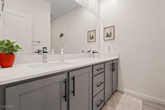 9710 Hiking Ave, Las Vegas, NV 89166 - bathroom with double vanity, baseboards, and wood finished floors