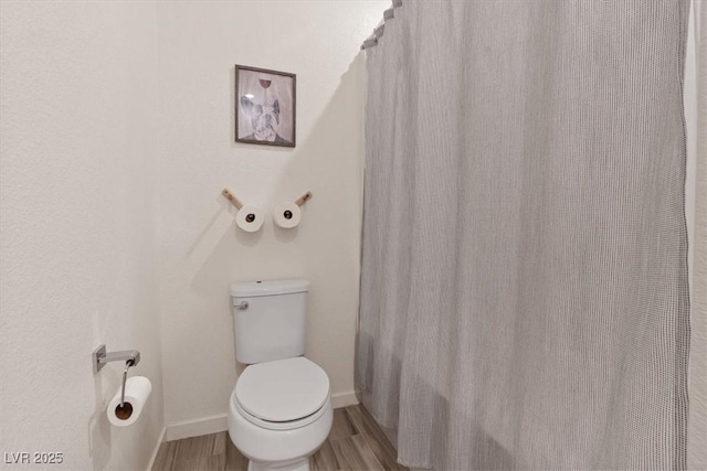 9710 Hiking Ave, Las Vegas, NV 89166 - bathroom featuring toilet, wood finished floors, curtained shower, and baseboards