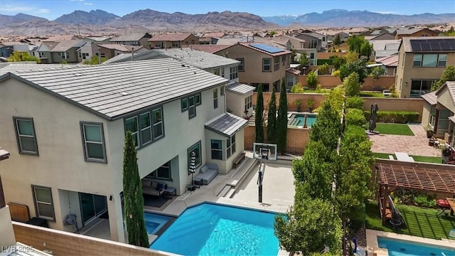 9710 Hiking Ave, Las Vegas, NV 89166 - rear view of property featuring a residential view, stucco siding, and a mountain view