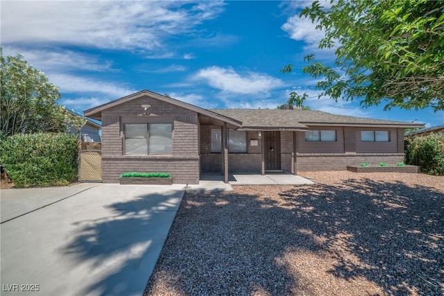ranch-style house featuring brick siding