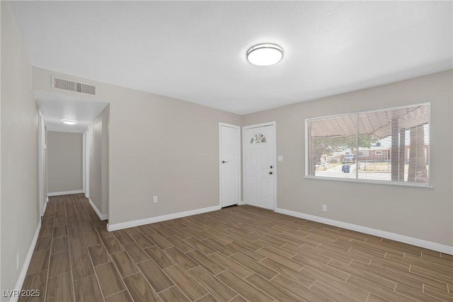 unfurnished room with wood finished floors and baseboards