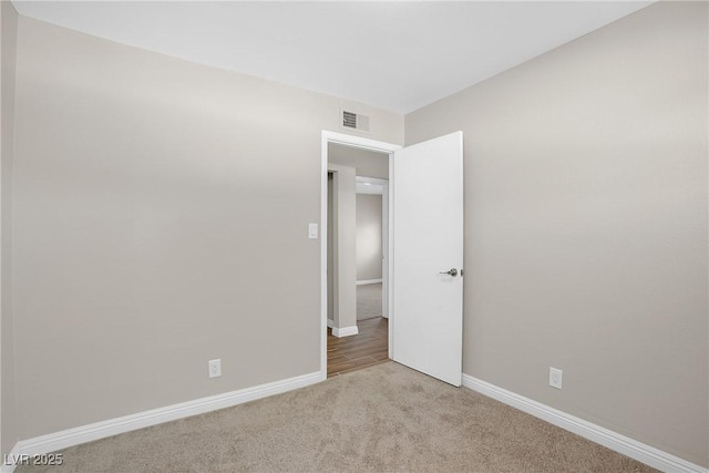 empty room with carpet floors and baseboards