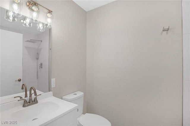 full bathroom featuring toilet, a shower, and vanity