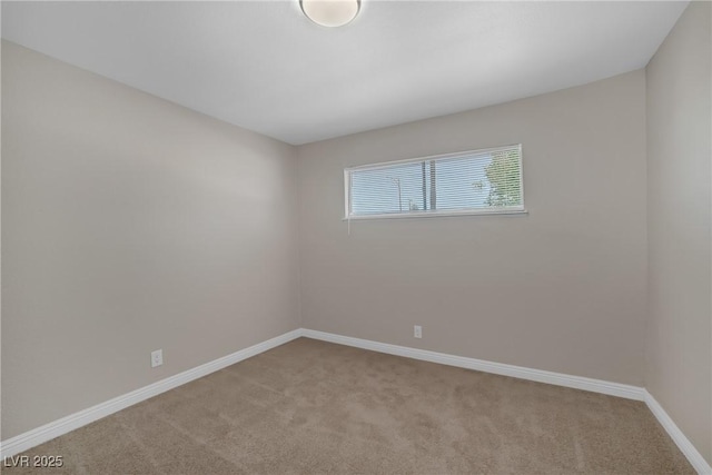 carpeted spare room with baseboards
