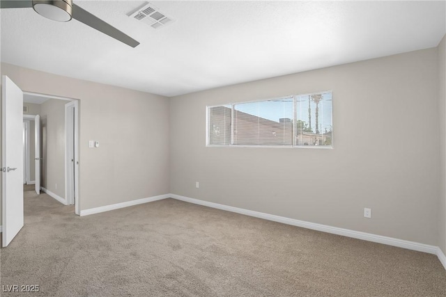 unfurnished room featuring light colored carpet, baseboards, and ceiling fan
