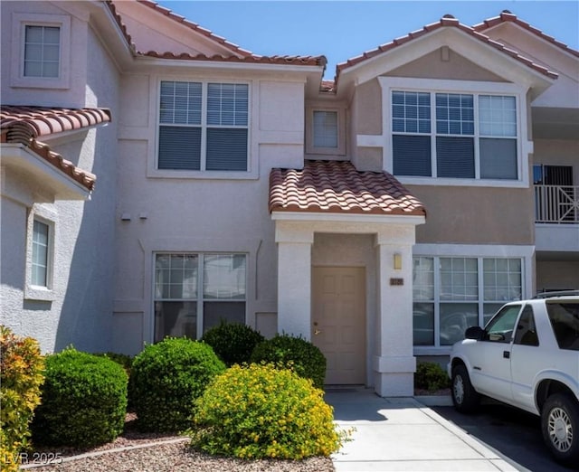 8555 W Russell Rd Unit 2020, Las Vegas, NV 89113 - view of property featuring a tile roof and stucco siding