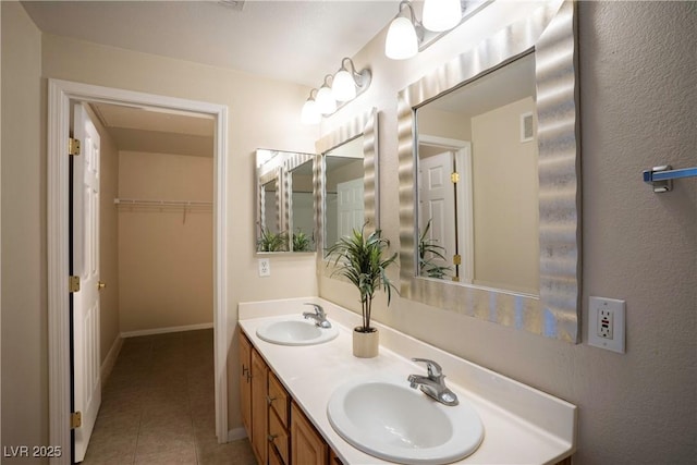 8555 W Russell Rd Unit 2020, Las Vegas, NV 89113 - bathroom featuring baseboards, tile patterned floors, and double vanity