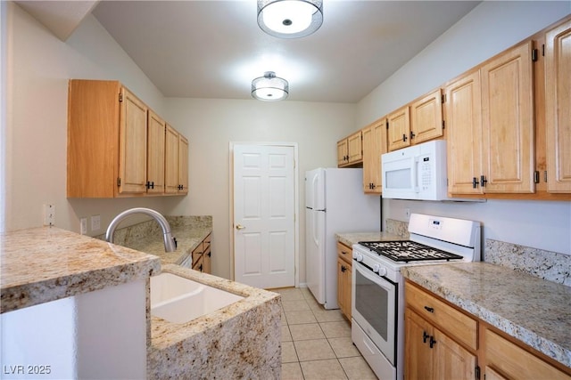 8555 W Russell Rd Unit 2020, Las Vegas, NV 89113 - kitchen featuring white appliances, a sink, light brown cabinets, light tile patterned floors, and light stone counters