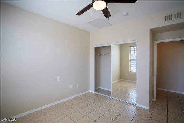 8555 W Russell Rd Unit 2020, Las Vegas, NV 89113 - unfurnished bedroom featuring light tile patterned floors, a closet, a ceiling fan, and baseboards