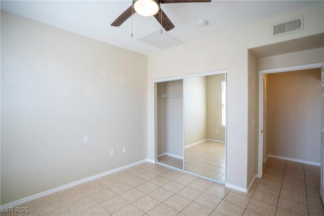 8555 W Russell Rd Unit 2020, Las Vegas, NV 89113 - unfurnished bedroom with a closet, light tile patterned flooring, ceiling fan, and baseboards
