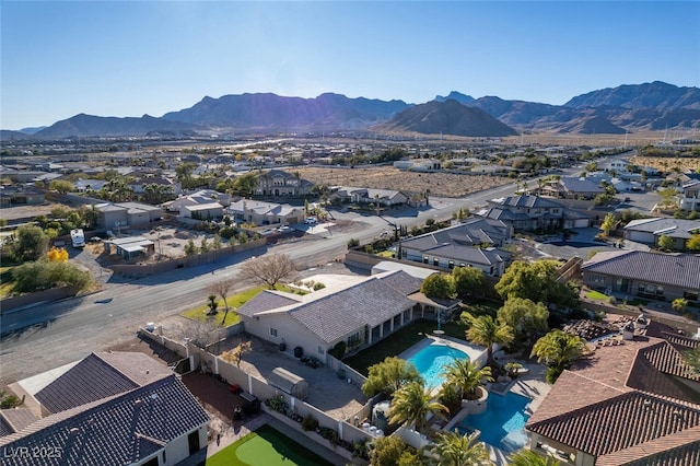10140 W Tropical Pkwy, Las Vegas, NV 89149 - aerial perspective of suburban area with a pool area and a mountainous background