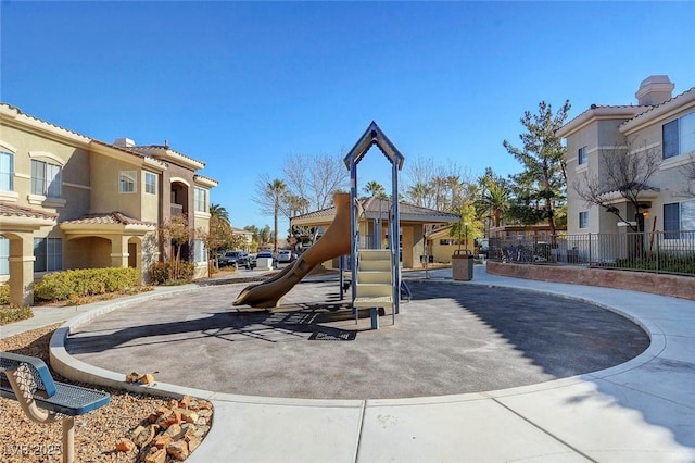 community jungle gym with a residential view
