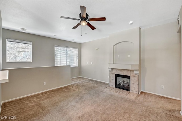unfurnished living room featuring carpet, ceiling fan, and baseboards
