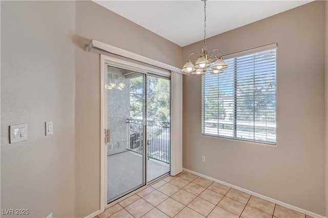 unfurnished dining area with baseboards, a chandelier, and light tile patterned floors