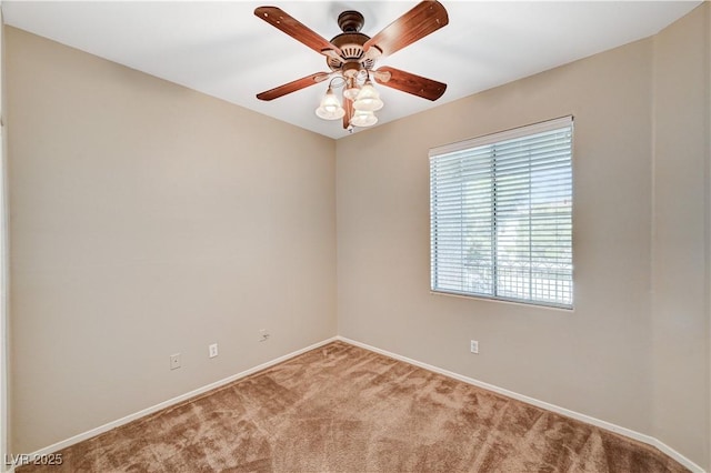 spare room featuring light carpet, baseboards, and ceiling fan
