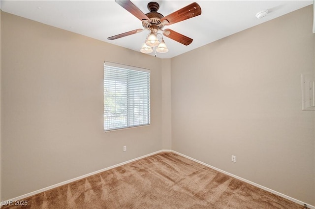 empty room with light colored carpet, a smoke detector, baseboards, and ceiling fan