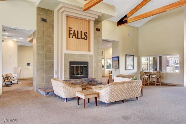living area with carpet floors, high vaulted ceiling, a tiled fireplace, beamed ceiling, and baseboards