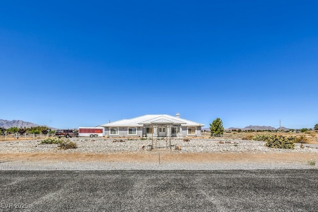 1410 Tiptop Trl, Pahrump, NV 89048 - view of front of home with a mountain view and a chimney