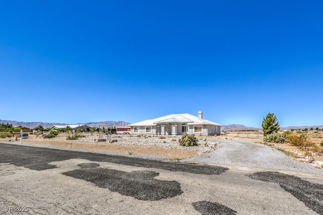 1410 Tiptop Trl, Pahrump, NV 89048 - view of front of property featuring a mountain view and a chimney