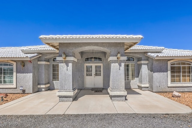 1410 Tiptop Trl, Pahrump, NV 89048 - doorway to property with stucco siding and a tile roof