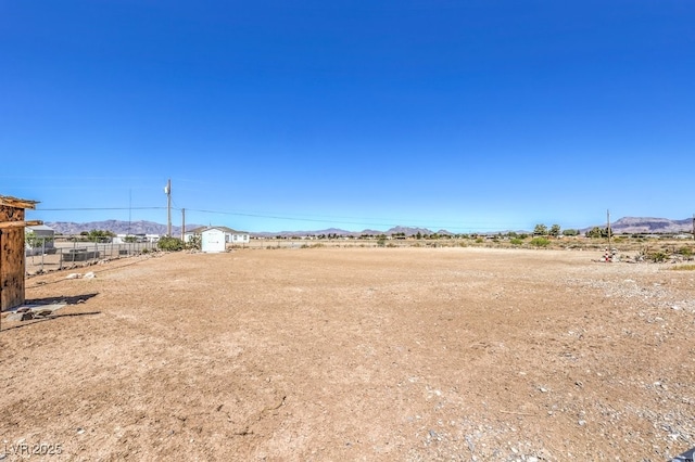 1410 Tiptop Trl, Pahrump, NV 89048 - view of yard with fence, a shed, an outdoor structure, and a mountain view