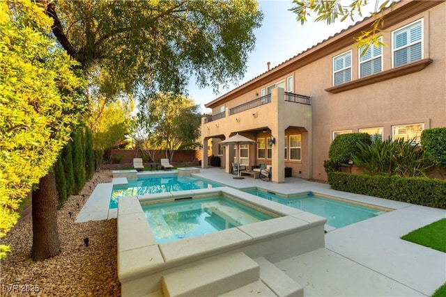 10002 Trapper Mountain St, Las Vegas, NV 89178 - view of swimming pool featuring an in-ground hot tub, a patio, and a fenced backyard