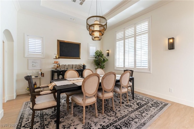 10002 Trapper Mountain St, Las Vegas, NV 89178 - dining room with ornamental molding, arched walkways, light wood-type flooring, a chandelier, and a tray ceiling
