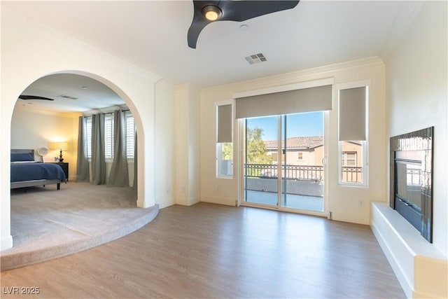 10002 Trapper Mountain St, Las Vegas, NV 89178 - living room with ornamental molding, wood finished floors, arched walkways, ceiling fan, and baseboards