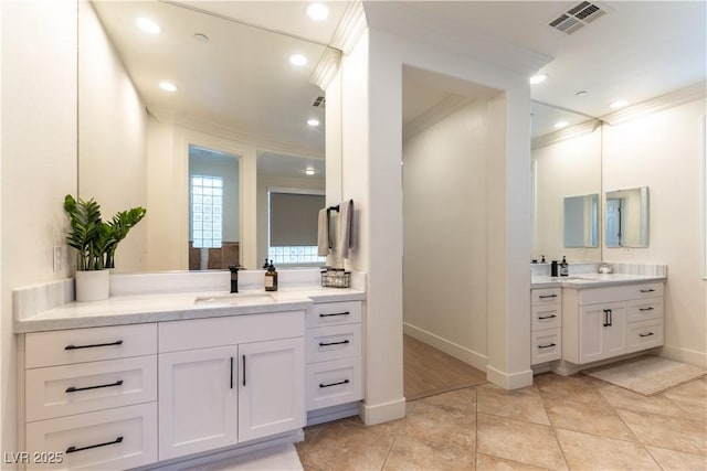 10002 Trapper Mountain St, Las Vegas, NV 89178 - bathroom featuring ornamental molding, two vanities, tile patterned floors, baseboards, and recessed lighting