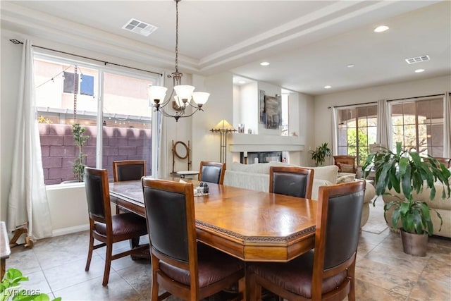8275 Old Creek Ranch St, Las Vegas, NV 89139 - dining room with a chandelier, light tile patterned flooring, recessed lighting, a glass covered fireplace, and baseboards