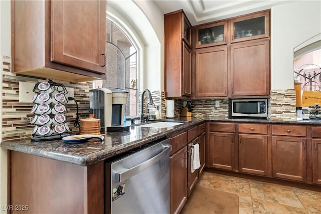 8275 Old Creek Ranch St, Las Vegas, NV 89139 - kitchen featuring stainless steel appliances, a sink, decorative backsplash, and dark stone countertops