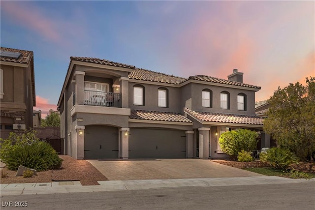 8275 Old Creek Ranch St, Las Vegas, NV 89139 - mediterranean / spanish-style house featuring a balcony, a garage, driveway, a tiled roof, and stucco siding