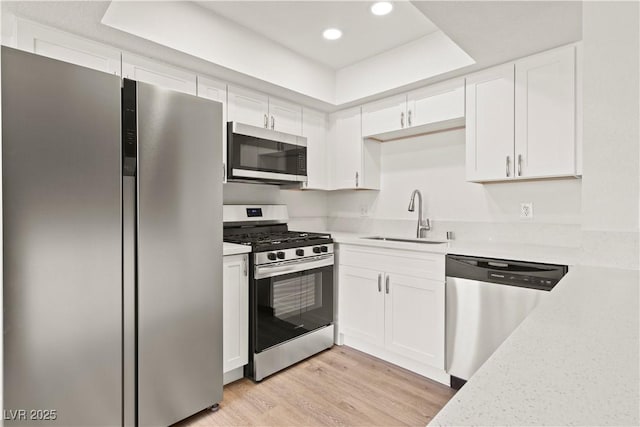 829 Rock Springs Dr Unit 201, Las Vegas, NV 89128 - kitchen with stainless steel appliances, a sink, white cabinetry, and recessed lighting