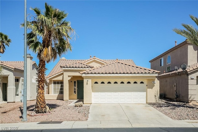 3416 Steppe St, North Las Vegas, NV 89032 - mediterranean / spanish home featuring a tile roof, a garage, stucco siding, and concrete driveway