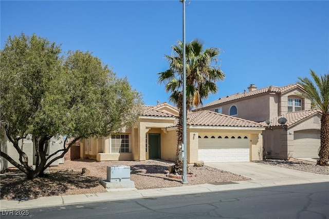 3416 Steppe St, North Las Vegas, NV 89032 - view of front facade featuring an attached garage, stucco siding, concrete driveway, and a tile roof